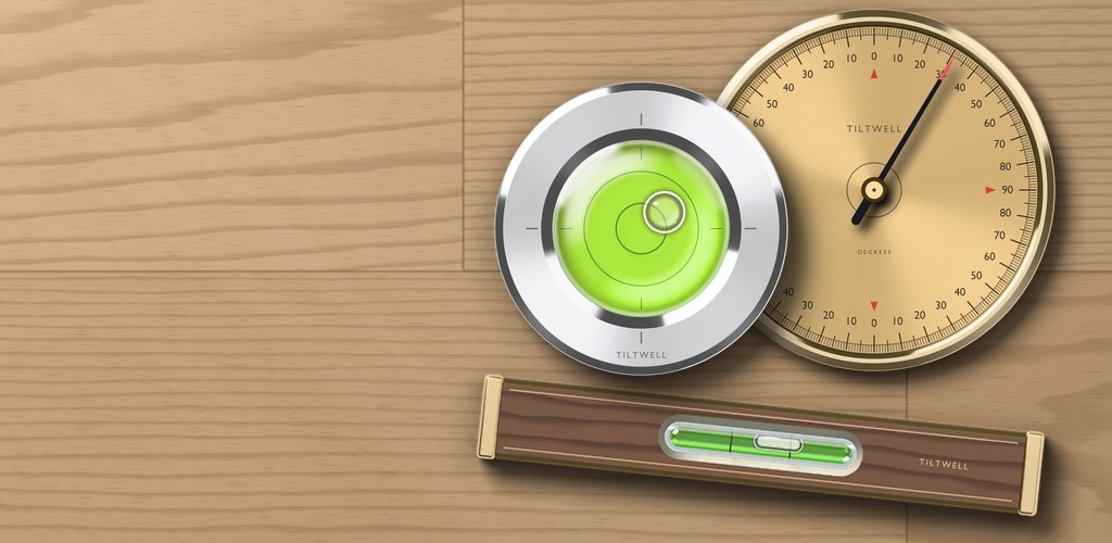 Tiltwell tools on a light wood workbench: an aluminum round bubble level with fluorescent green liquid, a brass protractor dial and a walnut bar level